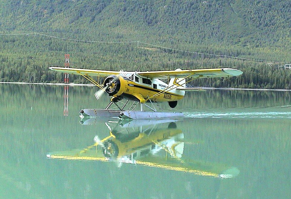 Yellow Norseman floatplane landing on Kenai Lake, Alaska